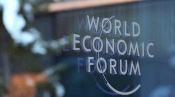 A logo sits on a glass panel inside the Kongress Zentrum, also known as Congress Center, the venue of the World Economic Forum (WEF) in Davos, Switzerland, on Monday, Jan. 19, 2015. This week World leaders, influential executives, bankers and policy makers will attend the 45th annual meeting of the World Economic Forum in Davos that runs from Jan. 21-24. Photographer: Chris Ratcliffe/Bloomberg via Getty Images
