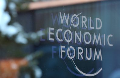 A logo sits on a glass panel inside the Kongress Zentrum, also known as Congress Center, the venue of the World Economic Forum (WEF) in Davos, Switzerland, on Monday, Jan. 19, 2015. This week World leaders, influential executives, bankers and policy makers will attend the 45th annual meeting of the World Economic Forum in Davos that runs from Jan. 21-24. Photographer: Chris Ratcliffe/Bloomberg via Getty Images